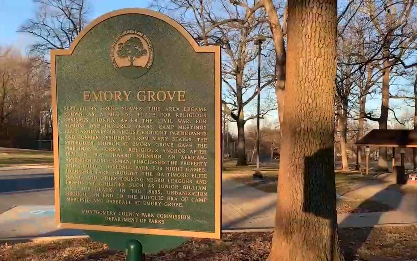 Photo of a bronze historical marker that reads